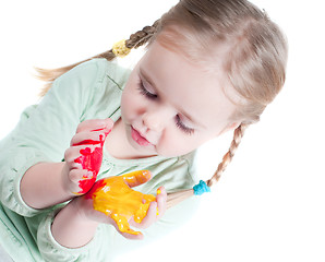 Image showing Little girl playing with colors