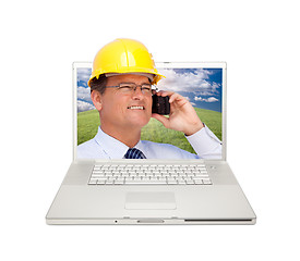 Image showing Laptop and Man with Hard Hat on Cell Phone