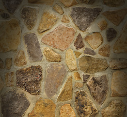 Image showing Masonry wall with irregular stones lit from above