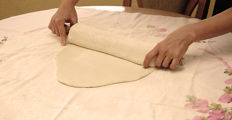 Image showing Hands with rolling pin preparing pastry