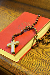 Image showing Hymnal  book and wooden rosary bead