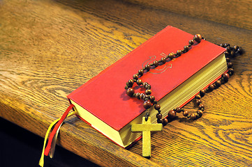 Image showing Hymnal  book and wooden rosary bead