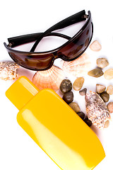 Image showing sunglasses, shells and lotion