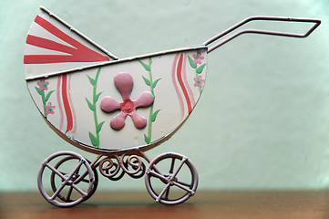 Image showing old painted buggy with flowers