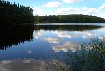 Image showing White clouds are floating in water of wood lake