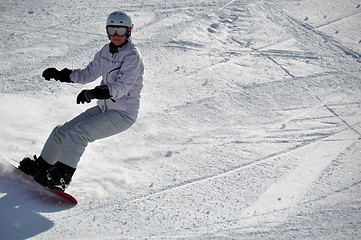 Image showing Female snowboarder in powder snow