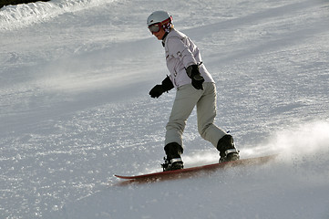 Image showing Female snowboarder in powder snow