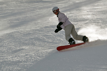 Image showing Female snowboarder in powder snow