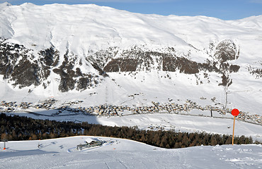 Image showing View down ski slope on chairlift station, valley and impressive mountains