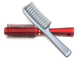 Image showing Two combs, red and sulfuric