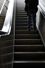 Image showing Man moving up with escalator