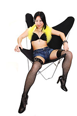 Image showing Asian girl lying in a butterfly chair.