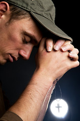 Image showing Praying Man Holding A Cross