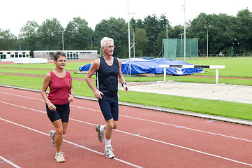 Image showing Senior Couple Running On A Track