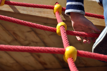 Image showing Boy climbing the ropes on playground