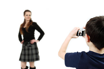Image showing Young boy with digital camera shooting girl