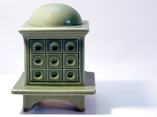 Image showing Miniature model of a tiled stove on white