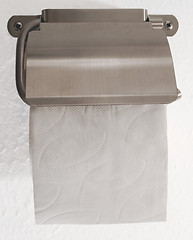 Image showing Toilet roll holder with toilet paper on white