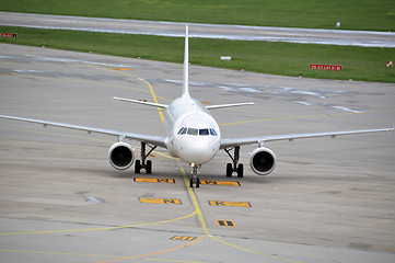 Image showing Airplane taxiing at large airport