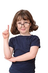 Image showing Little girl in round spectacles raising finger in attention gesture isolated