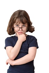 Image showing Thoughtful little girl in round spectacles rests her head on her hand isolated