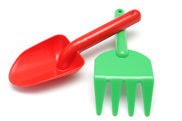 Image showing Red shovel and green rake toys
