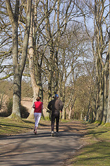 Image showing Couple jogging through park