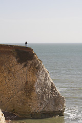 Image showing Couple standing on cliff edge