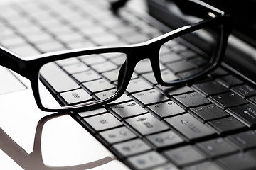 Image showing glasses on laptop