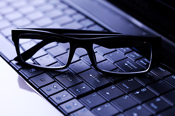 Image showing glasses on laptop