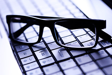 Image showing glasses on laptop