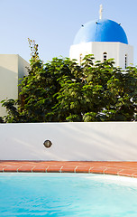 Image showing swimming pool with classic Greek Island church Santorini Greece