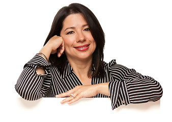 Image showing Attractive Multiethnic Woman Leaning on Blank White Sign Corner