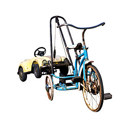 Image showing Trike with a Toy Car in Tow 