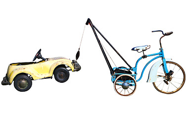 Image showing Trike with a Toy Car in Tow