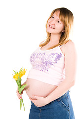 Image showing pregnant woman with yellow tulips 