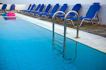Image showing Row of blue deck-chairs