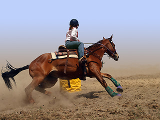 Image showing Cowgirl Rounding a Drum in the Barrel Race 