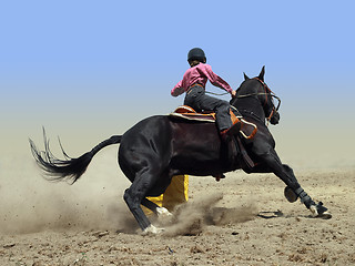 Image showing Cowgirl Rounding a Drum in the Barrel Race 