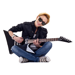 Image showing playing guitar seated