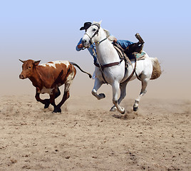 Image showing Cowboy Coming off his Horse after a Steer