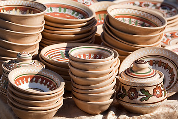 Image showing Stack of decorated handmade ceramic ware at the handicraft market