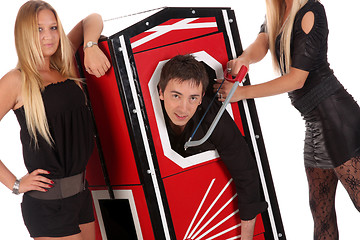 Image showing Magician performance and two beauty girls in a magic box with ha
