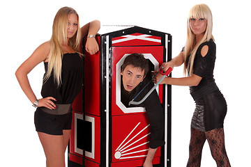 Image showing Magician performance and two beauty girls in a magic box with ha