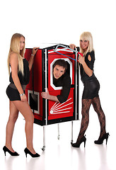 Image showing Magician performance and two beauty girls in a magic box with ha