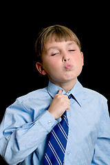 Image showing School boy adjusting tie