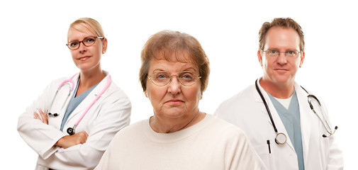 Image showing Concerned Senior Woman with Doctors Behind
