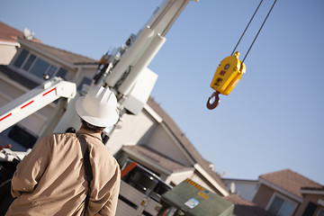Image showing Utility Worker Navigating Remote Crane