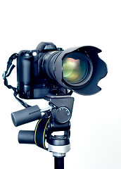 Image showing Professional digital SLR camera with telephoto zoom lens on tripod. Isolated white background 3