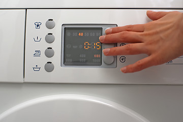 Image showing Adjusting a washing machine